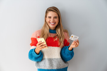 Laughing blonde woman holding cellphone