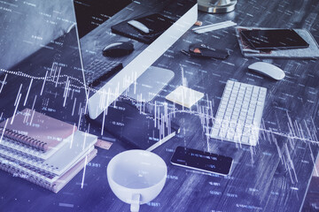 Double exposure of graph and financial info and work space with computer background. Concept of international online trading.
