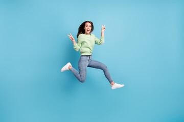 Fototapeta na wymiar Full length body size photo of funky friendly girl showing v-sign gesture with both hands jumping high smiling isolated on vivid blue color background