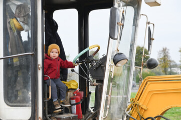 Little child driving a bulldozer © SYARGEENKA