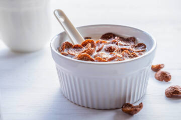 .Breakfast cereal with fresh milk on the white table