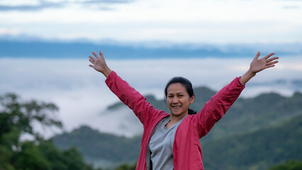 Young Asian women breathe the fresh air on the mountain 