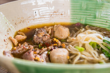 Popular street food in Thailand (Kuai Tiao Moo Namtok) that consisted of pork ball, pork meat, basil or thyme, bean sprouts, morning glory, noodle and creamy soup.