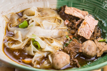Popular street food in Thailand (Kuai Tiao Moo Namtok) that consisted of pork ball, pork meat, basil or thyme, bean sprouts, morning glory, noodle and creamy soup.