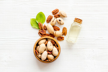 Layout of pecan nuts oil. Vegan food background, top view