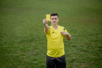 Referee showing a red card to a displeased football or soccer player while gaming. Concept of sport, rules violation, controversial issues, obstacles overcoming.