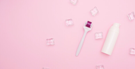 Body and skin care, cosmetology. White plastic containers for cosmetics and creams and mesoroller. Ice cubes, free space for text, top view.