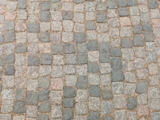 Abstract background of old cobblestone pavement view from above.