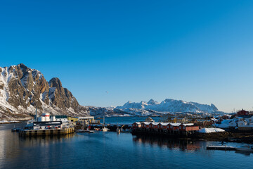 Fototapeta na wymiar View over the port and winter mountain landscape of Svolvaer on the Lofoten islands in morning sunrise in winter with snow