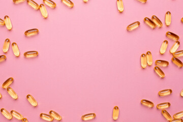 Vitamins Omega 3 6 9 fish oil , vitamin D on a pink background for health lifestyle with copyspace