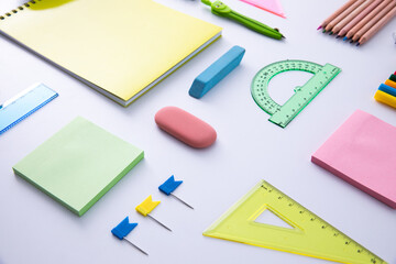 collection of bright colorful stationery on light background, close view . High quality photo