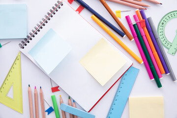 collection of bright colorful stationery on light background, close view . High quality photo
