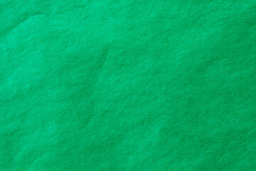 Green crumpled paper texture background.