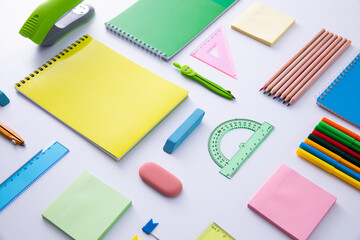 collection of bright colorful stationery on light background, close view . High quality photo