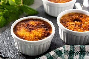 Homemade creme brulee on gray stone