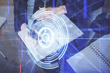 Double exposure of writing hands on background with data solution hologram on front. Technology concept. TOP view.