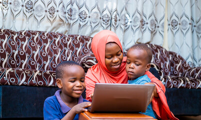 black african family using laptop at home