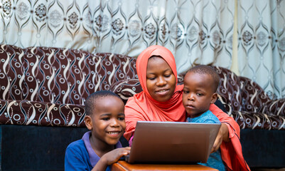 black african family doing home schooling with digital laptop during quarantine period - obrazy, fototapety, plakaty