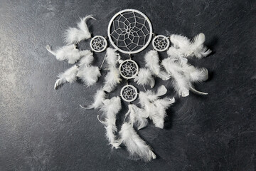 occult science and supernatural concept - dreamcatcher on dark slate stone background