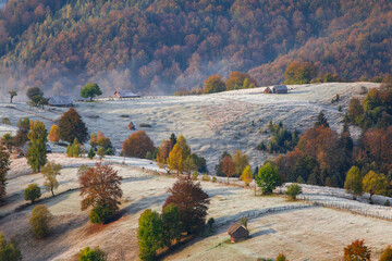 Autumn scene in Romania with hoarfrost over the Carpathian hills, in Transylvania village