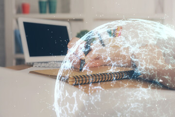 Social network theme hologram over woman's hands writing background. Concept of international people connect. Double exposure