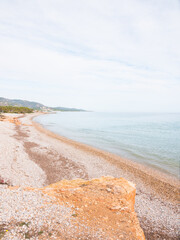 Beautiful pebble/stone beach. Paradise atmosphere with nobody. Mesmerizing coastline on a sunny day. Perfect desktop background.