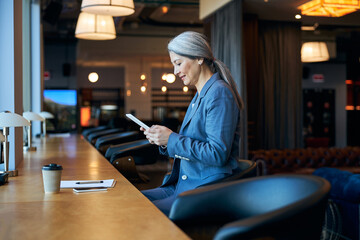 Charming woman using tablet computer in cafe