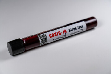 Positive COVID-19 blood sample tube. Close-up isolated on white background. Corona virus