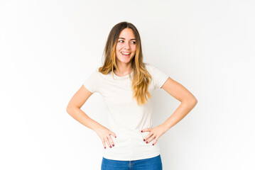 Fototapeta premium Young caucasian woman isolated on white background laughs and closes eyes, feels relaxed and happy.