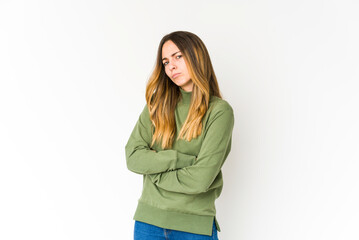 Young caucasian woman isolated on white background frowning face in displeasure, keeps arms folded.