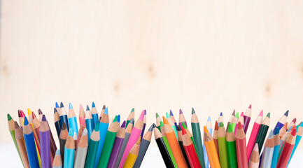 Colorful sharp crayons on wooden backround with copy space. Drawing and art with pencil made from wood. 