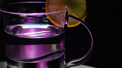 close up view of designer glass with slice of a lemon at the top