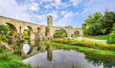 Fototapeta na wymiar Stone bridge across a river with tower in Besalu town, Catalan, Spain