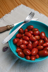 bowl full of delicious ready-to-eat cherry tomatoes. Vertical shot.