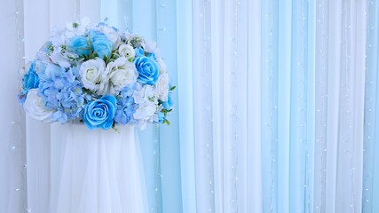 Wedding backdrop with blue flowers and wedding decorations.