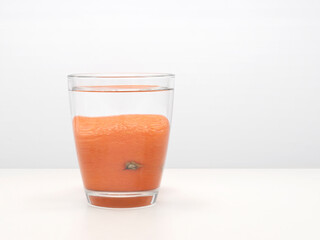 Glass of orange and water. Refraction.