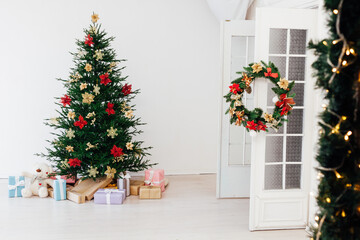 Fototapeta na wymiar Garland Christmas tree pine with gifts for the new year decor interior red white