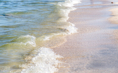 Beautiful closeup focus shot of sea waves hitting the shore