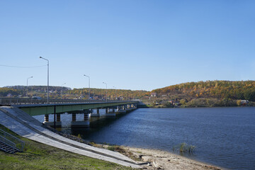 Fototapeta na wymiar Modern bridge over the river for transport