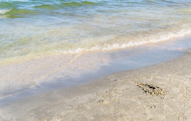 Beautiful closeup focus shot of sea waves hitting the shore