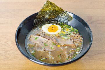 Asian noodle soup with meat and sesame seeds