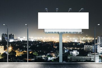 Empty billboard on night city background.