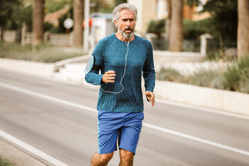 Active senior man jogging on a sunny day