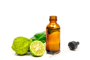 Bergamot oil in bottle and fresh bergamot fruit with green leaf isolated on white background.