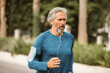 Active senior man jogging on a sunny day