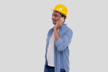 Construction Worker Talking on the Phone. Architect Holding Phone. Yellow Hard Helmet. Man Isolated Talking on Phone. Man Having a Call at Work