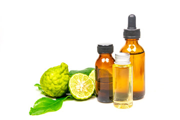 Bergamot oil in bottle and fresh bergamot fruit with green leaf isolated on white background.