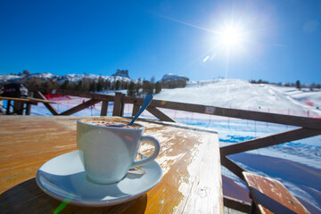 Cappuccino coffee in cafe at ski resort