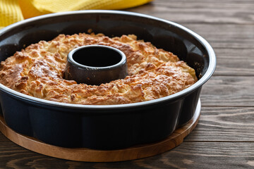 Delicious and fragrant crispy cupcake with apple pieces on a wooden table