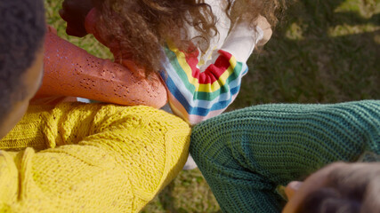 Top view of happy young family elbow bumping outdoors